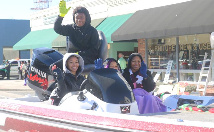 Children atop the Trinity United Methodist Church float wave at the crowd as the float heads down Marion Avenue during Monday’s MLK Jr. parade. (TONY BRITT/Lake City Reporter)