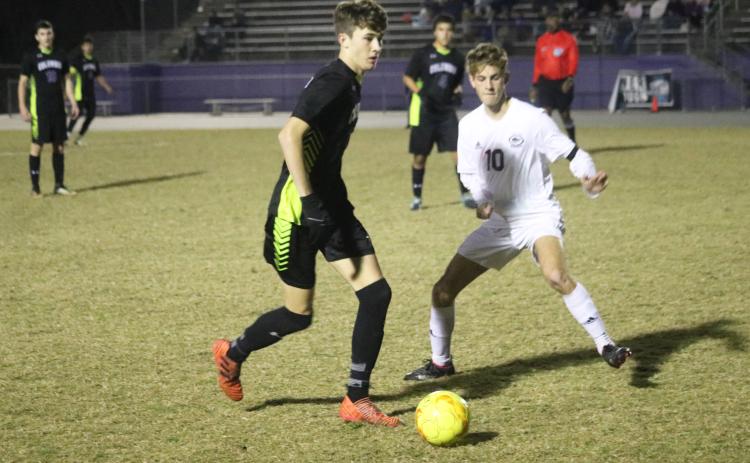 Columbia’s Max Bavar dribbles past Chiles’ Robbie Allman on Tuesday night. (JORDAN KROEGER/Lake City Reporter)