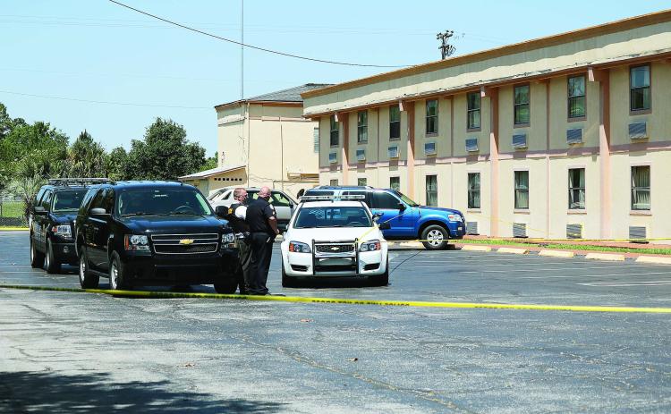 Officers at the scene of a homicide at the Ramada Limited motel on U.S. 90 in 2016. (FILE)