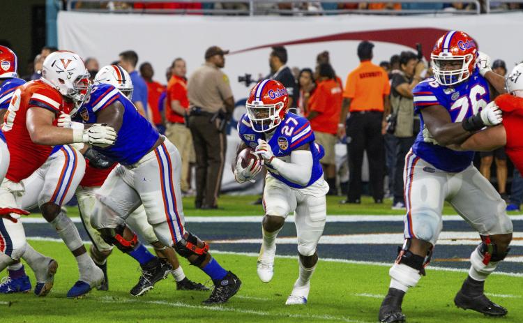Florida running back Dameon Pierce (27) runs for a first down against Virginia during the 2019 Capital One Orange Bowl at Hard Rock Stadium on Monday, in Miami Gardens. (AARON GILBERT/Icon Sportswire via AP)