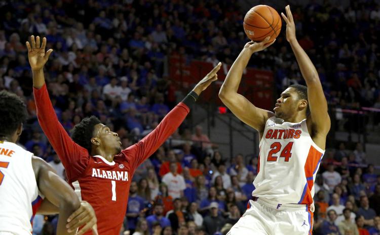 Florida forward Kerry Blackshear Jr. takes a jump shot over Alabama's Herbert Jones (1) during Saturday’s game at the O’Connell Center. (TRIBUNE NEWS SERVICE)