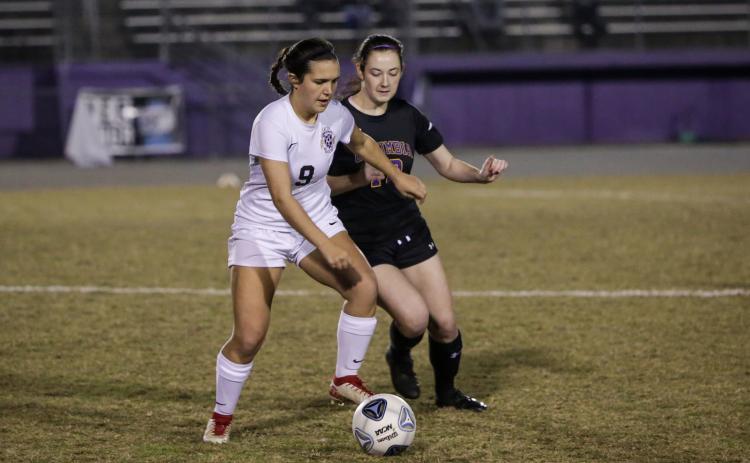 Columbia’s Kirsten Garner fights for possession of the ball with Leon’s Ashley Fink during Monday night’s District 2-6A quarterfinals. (BRENT KUYKENDALL/Lake City Reporter)