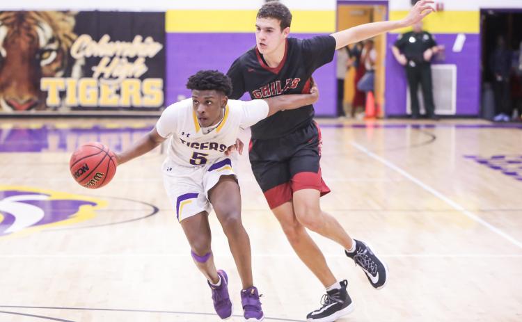 Columbia guard Darrien Jones drives by Chiles froward Sam Hartmann during Thursday's Region 1-6A quarterfinal. (BRENT KUYKENDALL/Lake City Reporter)