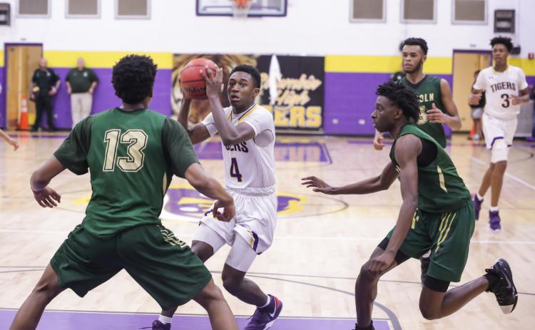 Columbia guard Kenney Gaines looks to pass as Lincoln’s defenses closes in during Tuesday’s Region 1-6A semifinal. (BRENT KUYKENDALL/Lake City Reporter)