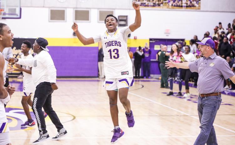 Columbia guard Tray Tolliver celebrates after defeating Daytona Beach Mainland 70-65 in Friday night’s Region 1-6A final. (BRENT KUYKENDALL/Lake City Reporter)