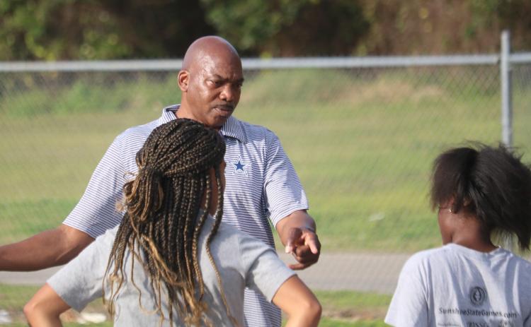 Columbia coach Lawrence Davis talks to his athletes during Wednesday’s practice. (JORDAN KROEGER/Lake City Reporter)