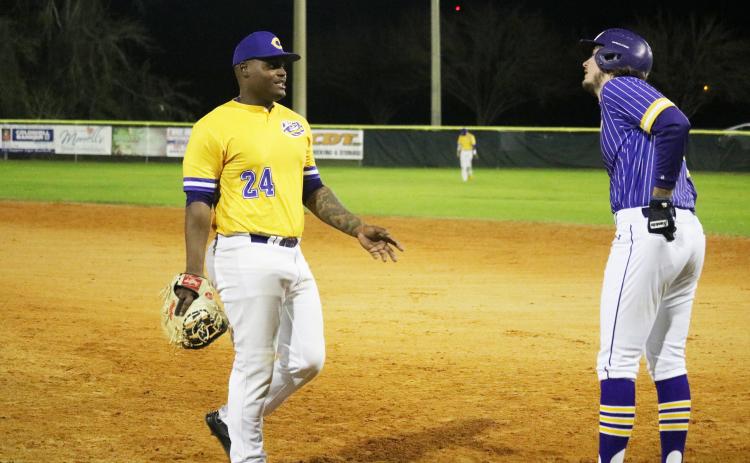 Columbia first baseman Daylon Lumpkin talks to Lance Minson after Minson reached first base safely during the Purple & Gold scrimmage Friday night. (JORDAN KROEGER/Lake City Reporter)