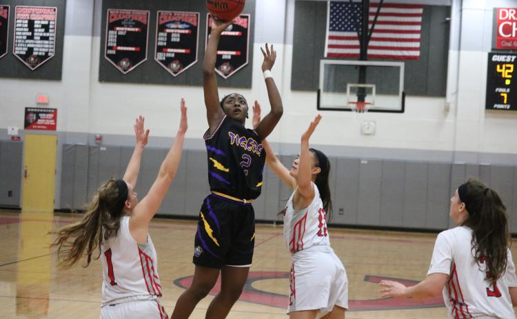 Columbia guard Na’Haviya Paxton shoots over Creekside’s defense during Thursday’s Region 1-6A quarterfinal. The Lady Knights won 65-50. (ZACH ABOLVERDI/Lake City Reporter)