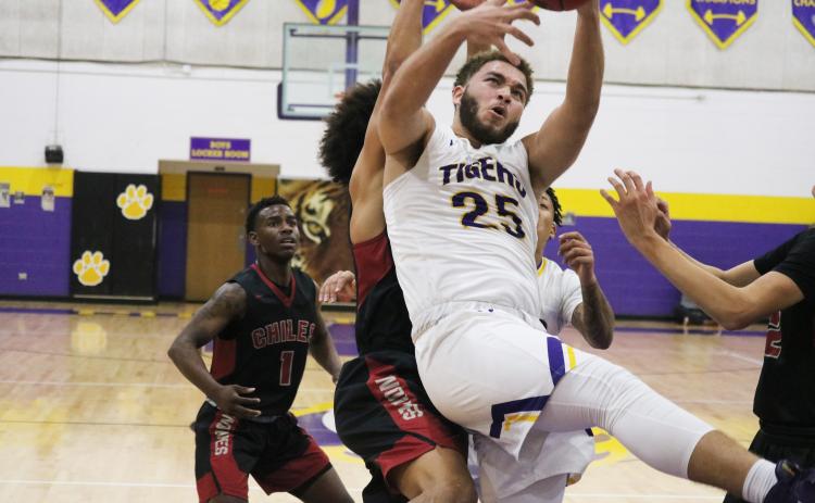 Columbia center Marcus Owens grabs a rebound in traffic against Chiles during Friday’s District 2-6A semifinal. (JORDAN KROEGER/Lake City Reporter)