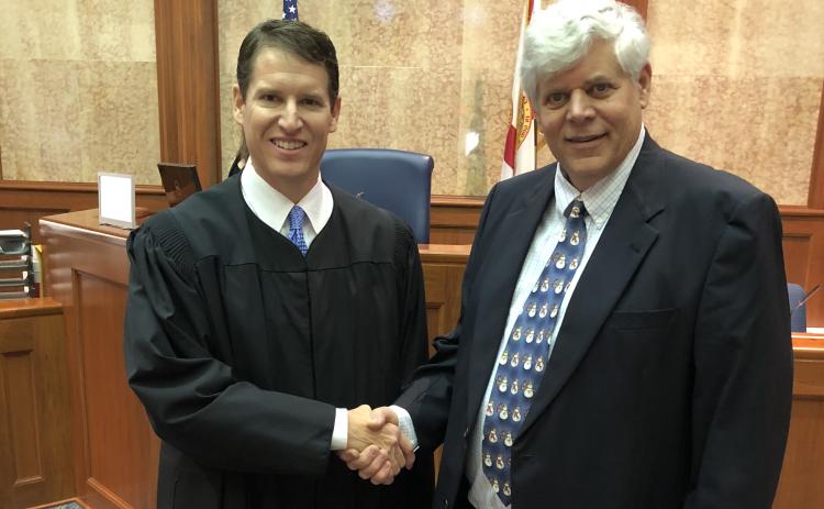 Interim Third Circuit State Attorney Dave Phelps shakes hands with Judge Mark Feagle after his swearing in December. (FILE)