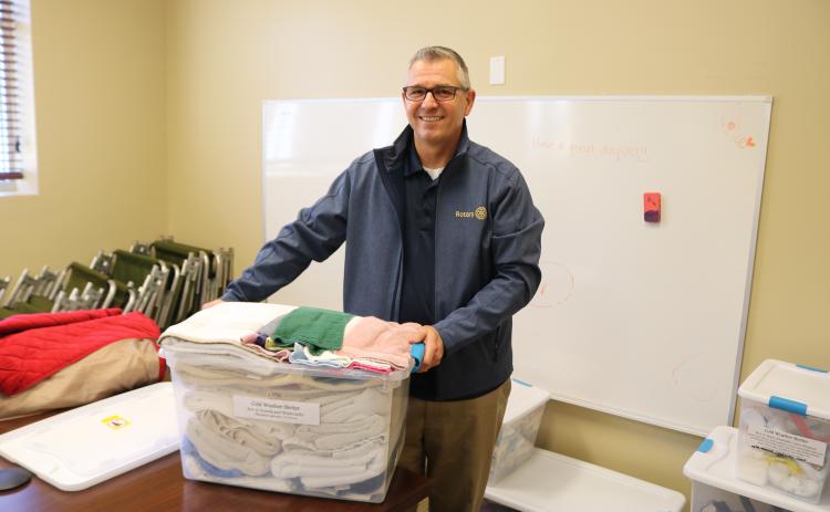 Mike Tatem, Parkview Baptist Church pastor, moves a container of towels and other toiletries on Thursday while preparing to open the church’s cold weather shelter. (TONY BRITT/Lake City Reporter)