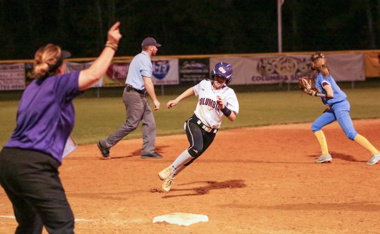Columbia coach Trudy Andrews waves home Morgan Hoyle as she heads toward third base against Chiefland on March 10. (BRENT KUYKENDALL/Lake City Reporter)