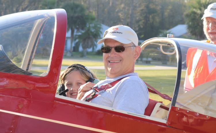 Mark Wiencek and Symphony Green, 8, get ready to take off from Cannon Creek Airpark and fly over Lake City as part of the Experimental Aircraft Association’s Young Eagles Rally on Saturday. (AMY HIETT/Special to the Reporter)