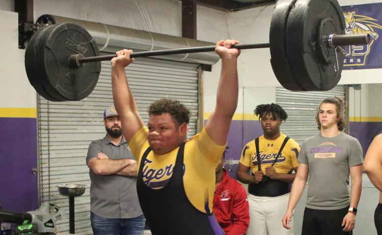 Columbia’s Nate Walsmley finishes his clean and jerk during Wednesday’s meet against Buchholz. Walmsley won the heavyweight class with a 600-pound total. (JORDAN KROEGER/Lake City Reporter)