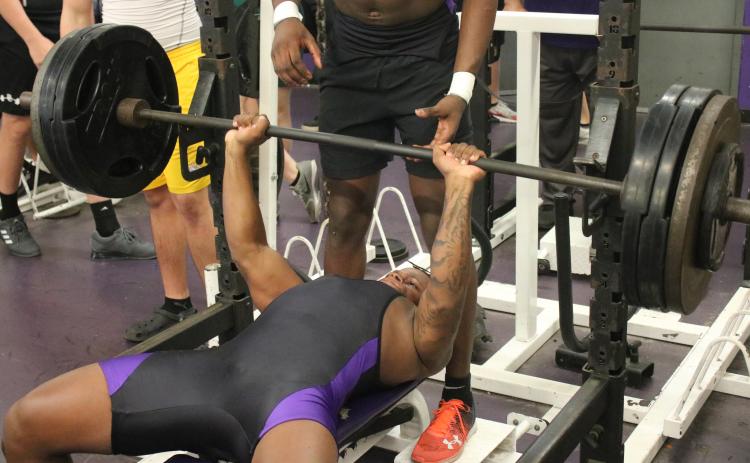 Columbia’s Marlon Pollock bench presses during a meet on March 11. (JORDAN KROEGER/Lake City Reporter)