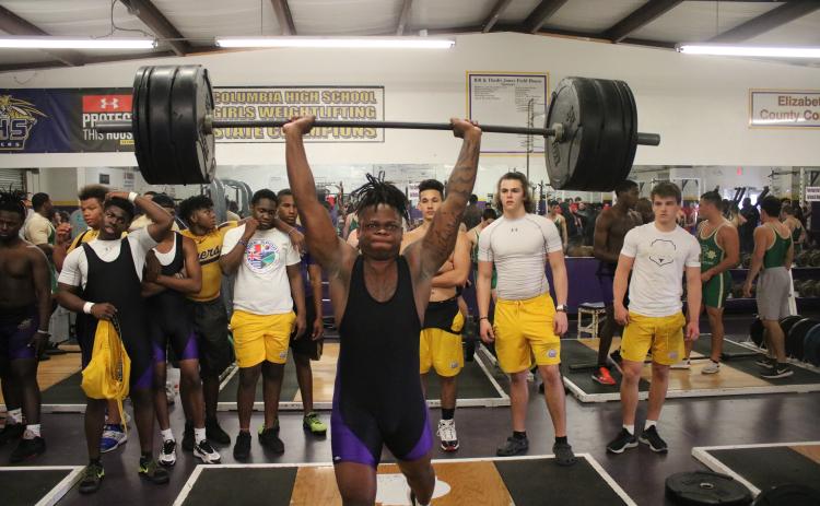 Columbia’s Marlon Pollock performs the clean and jerk during Wednesday’s tri-meet against Fleming Island and Baker County. (JORDAN KROEGER/Lake City Reporter)