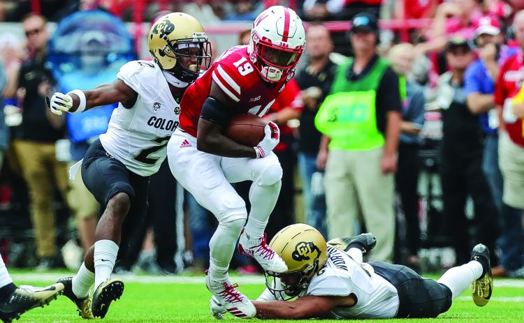 Nebraska Cornhuskers receiver Mike Williams escapes a tackle from Colorado Buffaloes defensive back Evan Worthington while defensive back Ronnie Blackmon attempts to make a tackle at Memorial Stadium on Sept. 8, 2018, in Lincoln, Neb. (MICHAEL SPOMER/Cal Sport Media via AP)