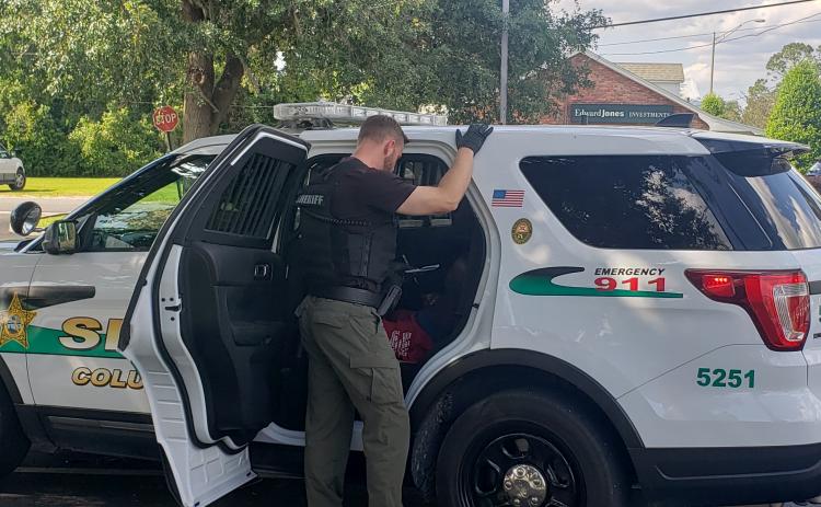 Cpl. Shane Foote of CCSO is seen speaking to a suspect after his capture. (COURTESY CCSO)
