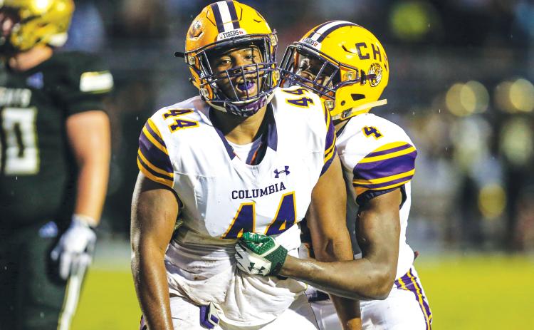 Columbia defensive lineman Terrick Ponds (44) is congratulated by linebacker Le’vontae Camiel (4) after a tackle for loss against Oakleaf on Aug. 30, 2019. (FILE)