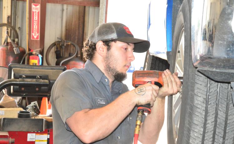Chris Shillito gets to work at Tire Mart of Lake City in late April. Business was slow then but has since ramped back up as cars return to the road. (CARL MCKINNEY/Lake City Reporter)