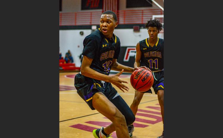 Columbia forward D’Andre Jefferson turns to drive to the basket against Fort White on Dec. 13, 2019. (THOMAS RICKS/Special to the Reporter)