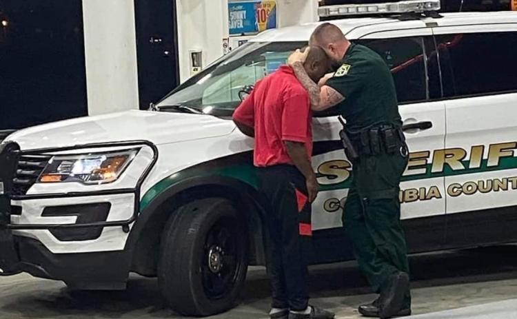 Deputy Chris Alford comforts a young man after an encounter with racists at a local store. (COURTESY CCSO)