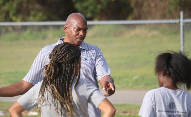 Columbia coach Lawrence Davis talks to his athletes during a track & field practice on Feb. 13. (FILE)