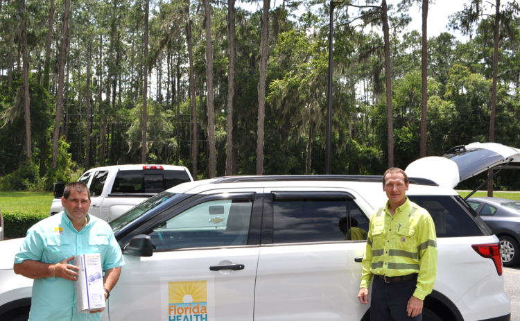 Tom Moffses, administrator, Columbia/Hamilton Health Department, left, is seen with William Ponton, general manager, Nutrien-White Springs. In the car are a total of 10,200 masks, a gift from Nutrien to the local DOH. (COURTESY)