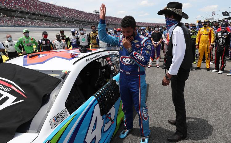 Bubba Wallace, driver of the #43 Victory Junction Chevrolet, and NASCAR Hall of Famer and team owner Richard Petty look on after NASCAR drivers pushed Wallace to the front of the grid as a sign of solidarity with the driver prior to the NASCAR Cup Series GEICO 500 at Talladega Superspeedway on Monday in Talladega, Ala. (CHRIS GRAYTHEN/Getty Images/TNS)