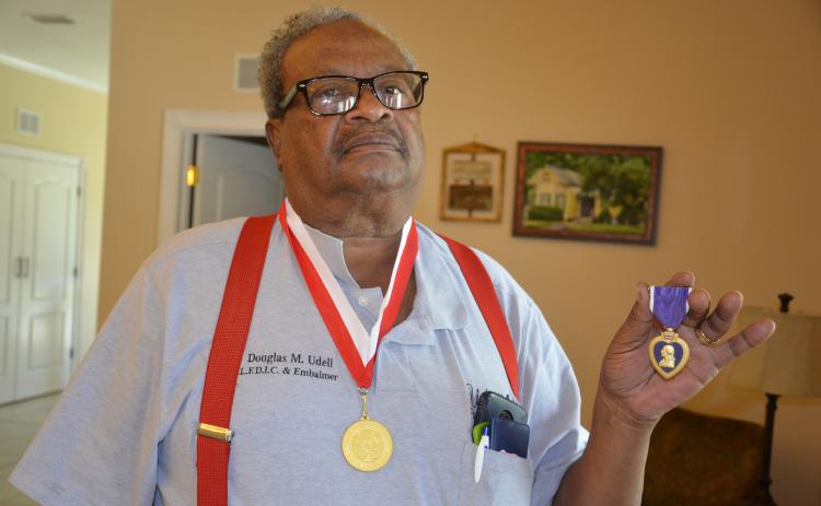 Doug Udell of Live Oak holds his purple heart, one of seven he received after Vietnam. Udell came out alive, but his friend, Joseph Pecora, wasn’t so lucky, kicking off the decades-long search for the fallen friend’s family. (CARL MCKINNEY/Lake City Reporter)