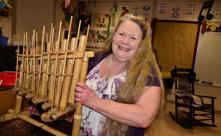 Eastside Elementary music teacher Teresa Cameron holds an angklung, an instrument originating in India. Cameron brought a large collection of world instruments with her when she joined Eastside 13 years ago. (CARL MCKINNEY/Lake City Reporter)