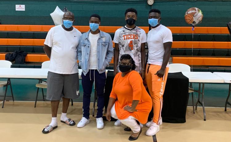 Columbia shooting guard Kenney Gaines is pictured with his family after signing his letter of intent to attend Marion Military Institute on Saturday. (COURTESY)