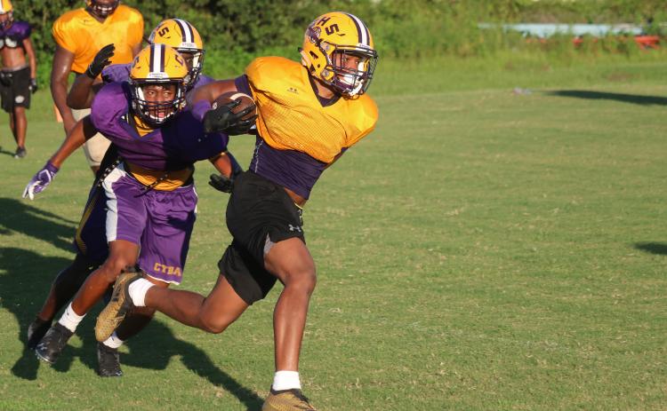 Columbia running back Jailen Brown rushes up the field as defensive back Dante Brown gives chase during a practice last August. (FILE)