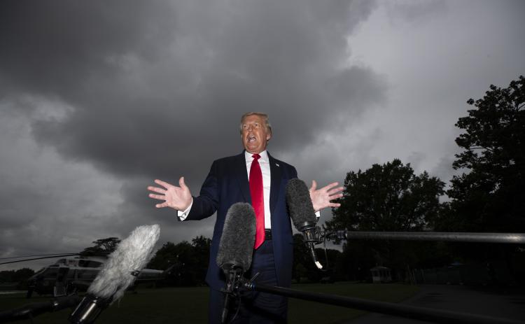 President Donald Trump speaks with reporters before walking to Marine One on the South Lawn of the White House on Friday in Washington. Trump is en route to Florida. (ALEX BRANDON/Associated Press)