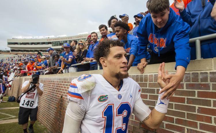 Florida quarterback Feleipe Franks (13) gets congratulated by fans after defeating Florida State 41-14 on Nov. 24, 2018, in Tallahassee. (AP FILE PHOTO)