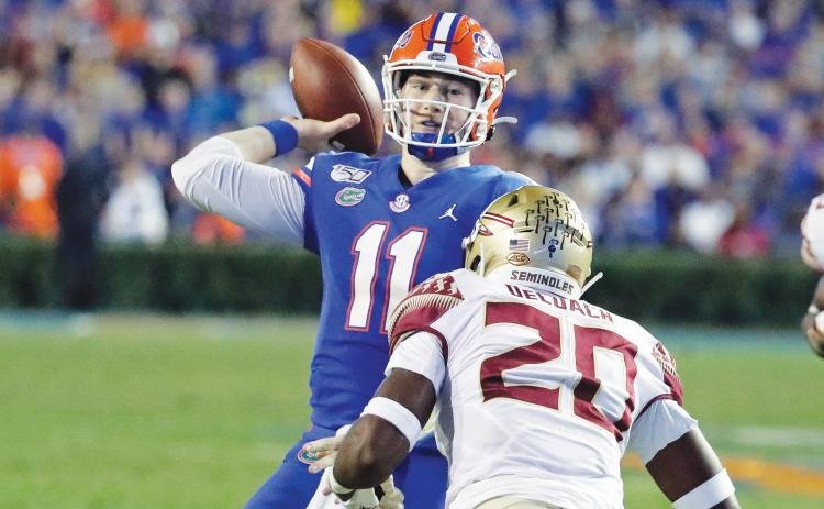 Florida quarterback Kyle Trask (11) throws a pass over Florida State linebacker Kalen DeLoach (20) during the first half of last year's game in Gainesville. (AP FILE PHOTO)