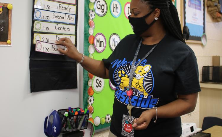 Karla Rodriguez, an Eastside Elementary School kindergarten teacher, places classroom schedules in packets as she prepares her classroom for the beginning of school on Monday morning. (TONY BRITT/Lake City Reporter)