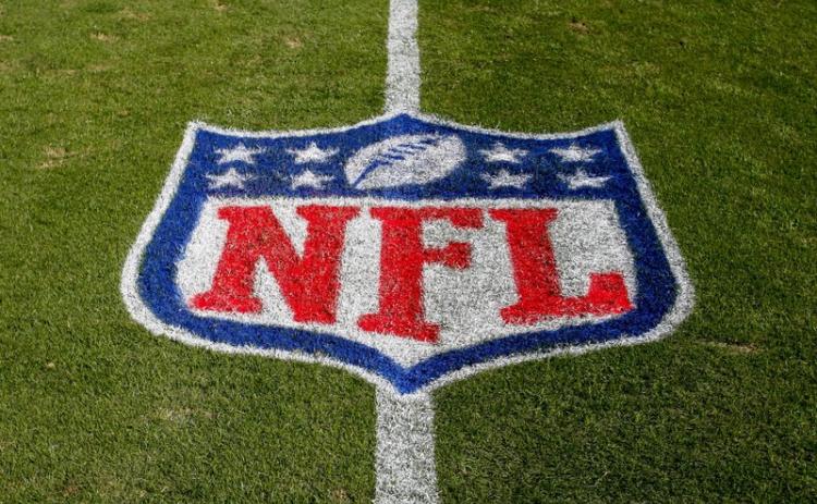 The NFL logo is displayed on the field at the Bank of American Stadium before a game between the Tampa Bay Buccaneers and the Carolina Panthers on Nov. 4, 2018, in Charlotte, N.C. The NFL revealed Sunday, that several positive covid-19 tests were found a day earlier by one of its testing partners, and the Chicago Bears said they had nine false positives. (AP FILE PHOTO)