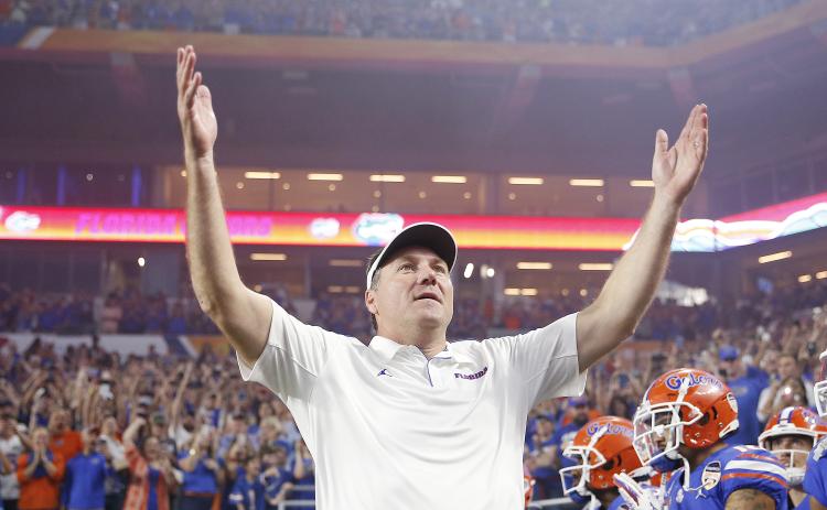 Florida head coach Dan Mullen pumps up the crowd prior to the start of the Capital One Orange Bowl against Virginia at Hard Rock Stadium last December. (MICHAEL REAVES/Getty Images/TNS)