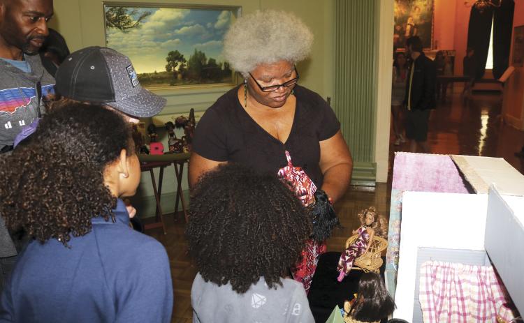 Shirley Marshall talks about her doll collection with guests during a diorama at the Stephen Foster Folk Culture Center State Park. Marshall owns more than 600 dolls, including more than 300 black dolls. (FILE)