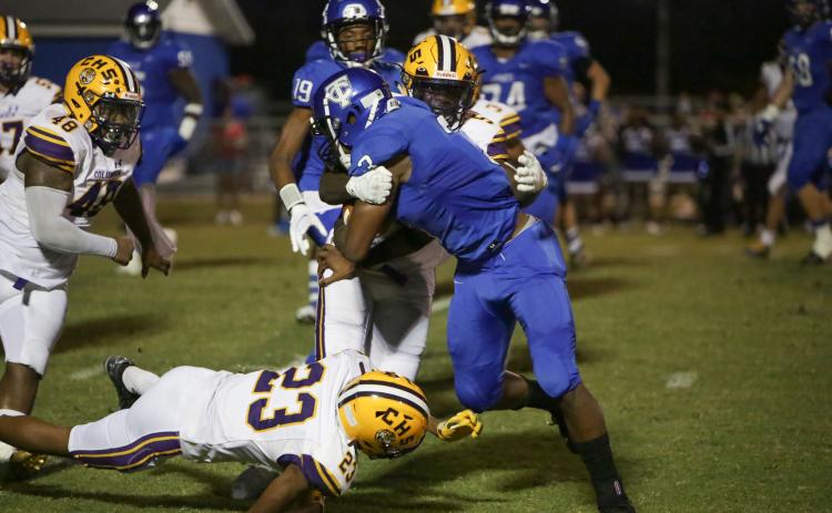 Columbia defensive back Jaden Robinson tackles Trinity Christian running back Treyaun Webb on Friday night. (BRENT KUYKENDALL/Lake City Reporter)