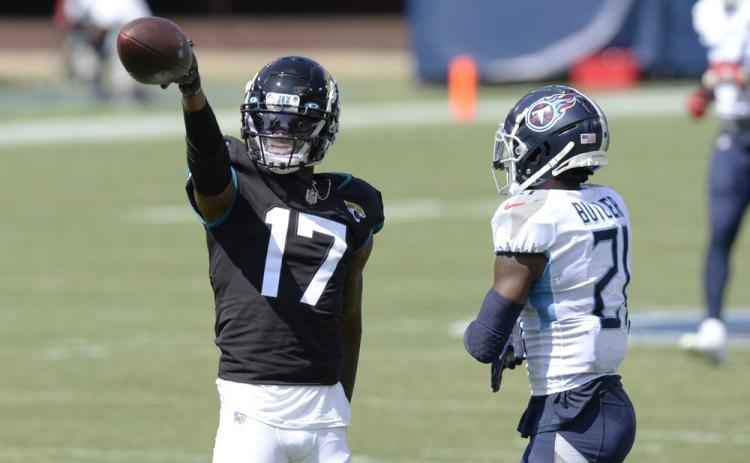 Jacksonville Jaguars wide receiver D.J. Chark (17) signals a first down after a reception against Tennessee Titans cornerback Malcolm Butler (21) on Sunday, in Nashville, Tenn. (MARK ZALESKI/Associated Press)