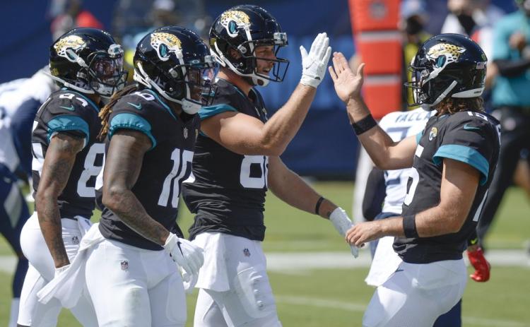 Jacksonville Jaguars tight end Tyler Eifert (88) is congratulated by quarterback Gardner Minshew, right, after teaming up for a 19-yard touchdown pass against the Tennessee Titans on Sept. 20, 2020, in Nashville, Tenn. (MARK ZALESKI)