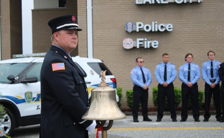 Daniel Dorn, a Lake City Fire Department driver/engineer, stands near a bell that was rung in honor of 9/11 terrorist attack victims Friday morning. (TONY BRITT/Lake City Reporter)