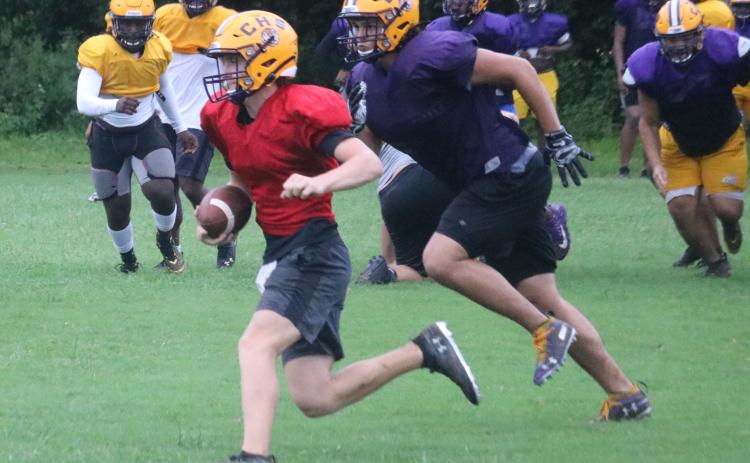 Columbia defensive end Jaiden Tillotson chases down quarterback Kade Jackson during Monday’s practice. (JORDAN KROEGER/Lake City Reporter)