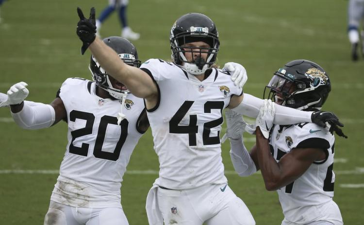 Jacksonville Jaguars safety Andrew Wingard (42) celebrates after intercepting a Indianapolis Colts pass with teammates safety Daniel Thomas (20) and Chris Chaisson, right, on Sunday, in Jacksonville. (STEPHEN B. MORTON/Associated Press))