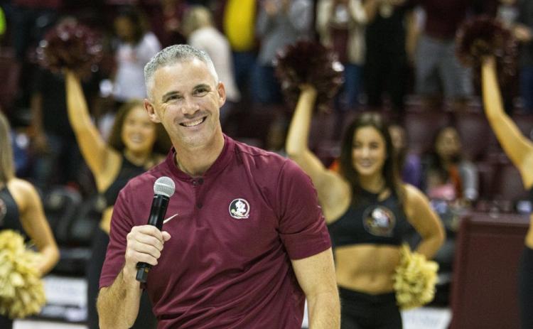 Florida State’s new head coach Mike Norvell smiles after being introduced during halftime of a basketball game against Clemson on Dec. 8, 2019, in Tallahassee. (AP FILE PHOTO)