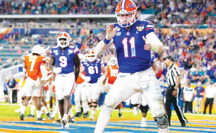 Florida Gators quarterback Kyle Trask (11) reacts after scoring on a two-point conversion late in the fourth quarter against the Virginia Cavaliers during the Capital One Orange Bowl at Hard Rock Stadium on Dec. 30, 2019, in Miami. (AL DIAZ/Miami Herald/TNS)