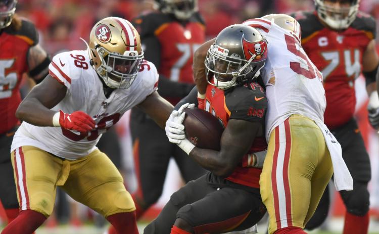 Tampa Bay Buccaneers running back Dare Ogunbowale (44) is tackled by San Francisco 49ers middle linebacker Fred Warner (54) in the fourth quarter on Sunday, Sept. 8, 2019 at Raymond James Stadium in Tampa. (ALLIE GOULDING/Tampa Bay Times/TNS)