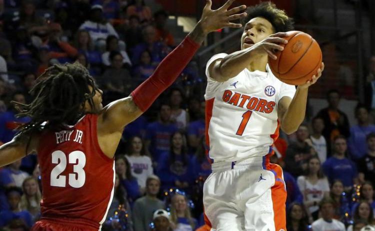 Florida guard Trey Mann goes for a shot around Alabama’s John Petty Jr. (23) last season at the O’Connell Center. (TRIBUNE NEWS SERVICE)